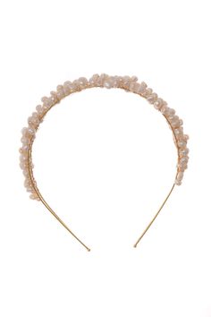 a headband with pearls and gold colored hair pins on top of white background, side view