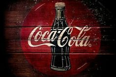 an old coca cola sign painted on wood