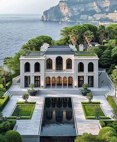 this is an aerial view of a mansion with a pool in the foreground and mountains in the background