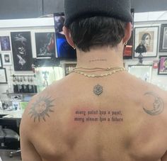 the back of a man's neck with tattoos on it, and an inscription that reads