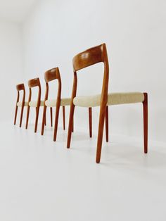 six chairs lined up in a row on a white surface