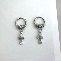 Elevate your streetwear game with our Cross Dangle Drop Earrings! Designed for both men and women, these hip hop-inspired earrings add an edgy touch to any outfit. With their unisex style, they are perfect for anyone looking to make a statement. Stand out from the crowd and express your unique style with these trendy earrings. Earrings length 1.5 inch width 0.3 inch. Streetwear Dangle Pierced Earrings, Streetwear Dangle Earrings, Trendy Metal Earrings For Streetwear, Single Metal Earring For Streetwear, Trendy Metal Hoop Earrings For Streetwear, Punk Dangle Earrings For Streetwear, Silver Trendy Hoop Earrings For Streetwear, Casual Metal Jewelry For Streetwear, Punk Pierced Hoop Earrings For Streetwear