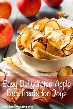 a bowl full of apple chips on top of a table with apples in the background and text overlay that reads easy dehydraed apple dog treats for dogs