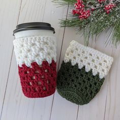 two crocheted coffee cups sitting next to each other on top of a table