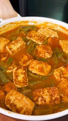 tofu and green beans stew in a white bowl