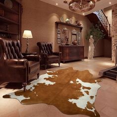 a living room filled with furniture and a cowhide rug