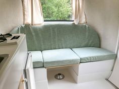 a kitchen area with a couch, stove and sink in it's centerpiece