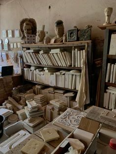 a room filled with lots of books and sculptures