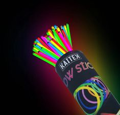 multicolored plastic straws are in a tube on a black background with neon colors