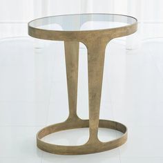 a glass and metal table sitting on top of a white tile floor next to a window