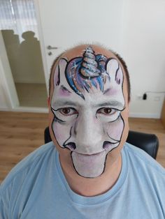 a man with his face painted to look like a unicorn