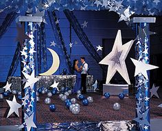 an outdoor stage set up with stars and moon decorations