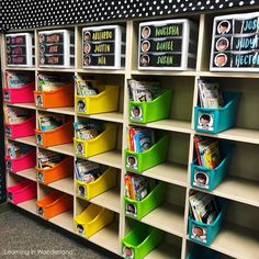 the shelves are filled with colorful bins for children's books to read and write