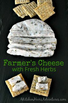 some crackers and cheese are on a black surface with the words farmer's cheese with fresh herbs