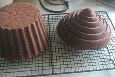 two cakes sitting on top of a cooling rack