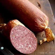 two sausages on a cutting board next to each other