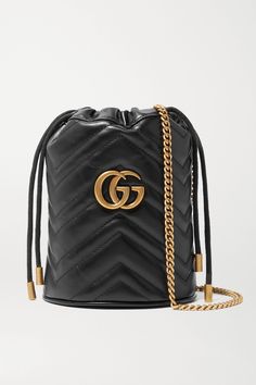 Gucci's extensive 'GG Marmont' collection wouldn't be complete without a mini bucket bag - plus, the compact silhouette is right in line with this season's most popular styles. It's been made in Italy from chevron quilted leather and features the signature gold logo embellishment. The suede-lined interior has two card slots, so you can forgo a wallet. Wear the chain strap over the shoulder or cross-body. Gg Marmont Mini Bucket Bag, Chevron Purse, Gucci Gg Marmont Mini, Gg Marmont Mini, Mini Bucket Bag, Gucci Crossbody, Mini Bucket Bags, Mini Bucket, Gucci Gg Marmont