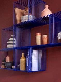 three blue shelves with different items on them