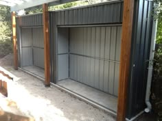 an open garage door on the side of a building with trees in the back ground