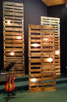 some wooden pallets with lights on them in the middle of a stage set up