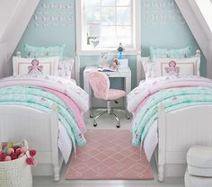 two beds in a room with blue walls and pink carpet