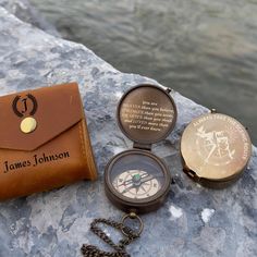 three different types of pocket watches sitting on top of a rock