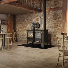 a wood burning stove in a stone walled kitchen