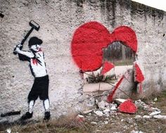 graffiti on the side of a building with a boy holding a baseball bat and heart