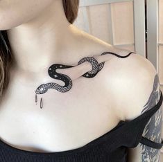 a woman with a snake tattoo on her shoulder