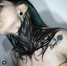 a woman with black hair and piercings on her neck