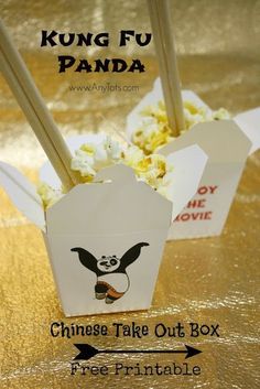 some popcorn and chopsticks are sitting in small boxes with panda stickers on them