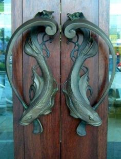 two metal doors with fish on them