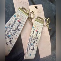 two key chains with the words happy birthday written on them are attached to each other