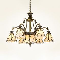 a chandelier with five lights hanging from it's sides and four lamps on each side