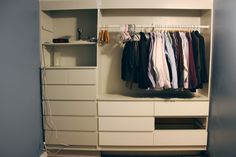 an organized closet with clothes hanging on the rails and drawers, along with other items