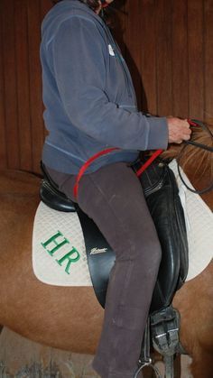 a woman riding on the back of a brown horse