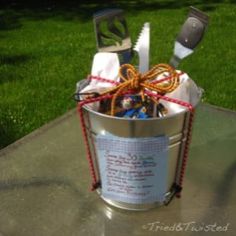 a metal bucket filled with lots of cooking utensils