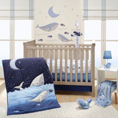 a baby's room is decorated in blue and white