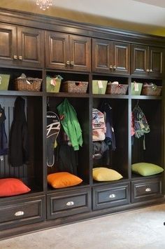 an organized mud room with lots of storage