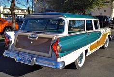 an old station wagon parked in a parking lot