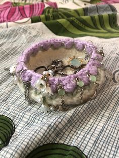 a close up of a bracelet on a bed