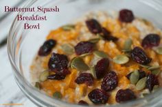 a glass bowl filled with oatmeal and cranberries