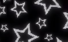 an array of pixelated stars and arrows on a black background, all in white