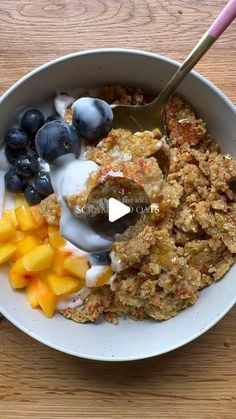 a bowl filled with oatmeal and fruit on top of a wooden table