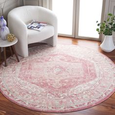 a white chair sitting in front of a pink rug