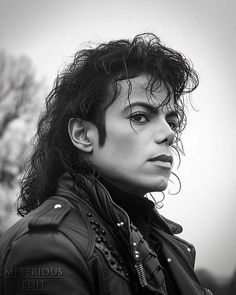 a black and white photo of a woman wearing a leather jacket