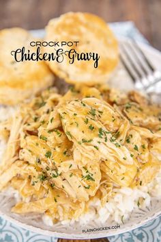 chicken and gravy is served over rice on a white plate with a fork