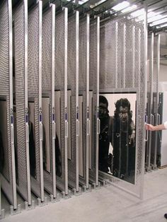 a man standing in front of a bunch of lockers with gorilla heads on them