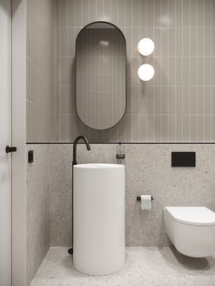 a bathroom with a sink, mirror and toilet paper dispenser in it