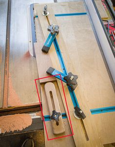 a pair of tools are sitting on top of a piece of plywood that has been cut in half